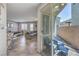 Open-concept living space with tile floors, neutral decor, and sliding glass doors to patio at 9208 S Park St, Las Vegas, NV 89178