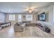Spacious living room featuring a plush sectional sofa, ceiling fan, and modern entertainment center at 9208 S Park St, Las Vegas, NV 89178