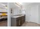 Elegant main bathroom with double sinks, granite counters, and tile floors at 9208 S Park St, Las Vegas, NV 89178