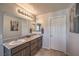 Main bathroom featuring double sinks with a granite countertop and neutral tones at 9208 S Park St, Las Vegas, NV 89178