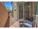 Cozy outdoor patio with seating, gravel landscaping, and a brick privacy wall at 9208 S Park St, Las Vegas, NV 89178