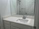 Bright bathroom featuring a single sink vanity with white countertop and a large mirror at 965 Nevada State Dr # 39102, Henderson, NV 89002