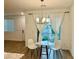 Cozy dining area with stylish table set near sliding glass doors and white curtains at 965 Nevada State Dr # 39102, Henderson, NV 89002