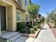 Well-manicured townhome exterior with a lush landscape and inviting walkway at 965 Nevada State Dr # 39102, Henderson, NV 89002