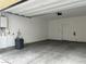 Spacious garage interior with water heater, water softener, and door to outside at 965 Nevada State Dr # 39102, Henderson, NV 89002