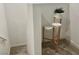 Hallway with stairway, showing a decorative tiered plant stand with greenery at 965 Nevada State Dr # 39102, Henderson, NV 89002