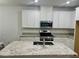Modern kitchen island with granite countertops and stainless steel appliances at 965 Nevada State Dr # 39102, Henderson, NV 89002