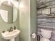 Half bathroom with decorative wood accent wall, shelves, and updated fixtures at 982 Sable Chase Pl, Henderson, NV 89011