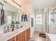 Bright bathroom featuring double sinks, walk-in shower, and lots of natural light at 982 Sable Chase Pl, Henderson, NV 89011