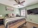 Cozy bedroom with comfortable bed, wall-mounted TV, and neutral decor at 982 Sable Chase Pl, Henderson, NV 89011