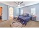 Primary bedroom with ceiling fan, bedside tables, a comfy pet bed, and ensuite bathroom entrance at 982 Sable Chase Pl, Henderson, NV 89011