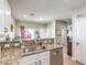 Open concept kitchen with stainless steel dishwasher and granite counters with breakfast bar seating at 982 Sable Chase Pl, Henderson, NV 89011