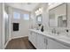 Bathroom featuring a double sink vanity with marble countertop, and a glass shower at 10270 Turkish Pine Ct, Las Vegas, NV 89166