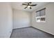 This bedroom features neutral walls, a ceiling fan, gray carpet and a window at 10270 Turkish Pine Ct, Las Vegas, NV 89166
