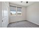 Cozy bedroom featuring neutral carpet, a ceiling fan, and two windows allowing ample natural light at 10270 Turkish Pine Ct, Las Vegas, NV 89166