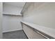 Walk-in closet with custom shelving, carpeted floor, and white walls at 10270 Turkish Pine Ct, Las Vegas, NV 89166
