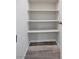 A walk-in closet with built-in shelves and wood-style tile flooring, offering ample storage space and organization at 10270 Turkish Pine Ct, Las Vegas, NV 89166