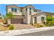 Two-story stucco home showcasing a paver driveway and a two-car garage under a brown tile roof at 10270 Turkish Pine Ct, Las Vegas, NV 89166