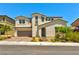 Elegant two-story home featuring a two-car garage, desert landscaping, and a neutral color palette at 10270 Turkish Pine Ct, Las Vegas, NV 89166