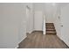 Entryway with a staircase, neutral walls, and wood-look tile flooring creates a welcoming and bright atmosphere at 10270 Turkish Pine Ct, Las Vegas, NV 89166