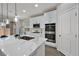 Kitchen island featuring pendant lights, stainless steel appliances, and marble countertops at 10270 Turkish Pine Ct, Las Vegas, NV 89166