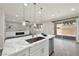 Kitchen island with sink, marble countertops, and sliding glass doors to the backyard at 10270 Turkish Pine Ct, Las Vegas, NV 89166