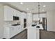 Well-equipped kitchen with white cabinets, marble countertops, and stainless steel appliances at 10270 Turkish Pine Ct, Las Vegas, NV 89166