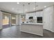Kitchen island with a sink, pendant lights, and sliding glass doors to the patio at 10270 Turkish Pine Ct, Las Vegas, NV 89166