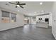 Bright living space with wood-look tile floors, recessed lighting, and access to the backyard through sliding glass doors at 10270 Turkish Pine Ct, Las Vegas, NV 89166