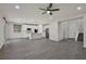Spacious open-concept living room features wood-look tile flooring and seamlessly connects to the modern kitchen at 10270 Turkish Pine Ct, Las Vegas, NV 89166