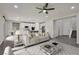 Spacious living room with a view of the modern kitchen and staircase at 10270 Turkish Pine Ct, Las Vegas, NV 89166
