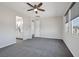 Main bedroom with gray carpet, a ceiling fan, and an ensuite bathroom at 10270 Turkish Pine Ct, Las Vegas, NV 89166