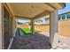 Back patio with tiled floors, faux grass lawn, and block wall perimeter at 10270 Turkish Pine Ct, Las Vegas, NV 89166