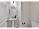 Chic powder room features a pedestal sink, modern mirror, and updated fixtures for a stylish, convenient space at 10270 Turkish Pine Ct, Las Vegas, NV 89166
