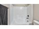 Close-up of a pristine white tiled bathtub and shower combination, designed for both relaxation and functionality at 10270 Turkish Pine Ct, Las Vegas, NV 89166