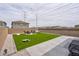 Backyard with concrete patio and artificial turf, perfect for entertaining and relaxation at 10292 Fragrant Apple Ct, Las Vegas, NV 89141