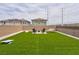 Enjoy the backyard with a fire pit, chairs, hammock, and artificial turf at 10292 Fragrant Apple Ct, Las Vegas, NV 89141