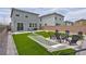 Relax in this beautiful backyard with artificial turf, hammock, and a cozy fire pit at 10292 Fragrant Apple Ct, Las Vegas, NV 89141