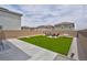 Backyard featuring artificial turf, a concrete patio, and a seating area with a fire pit at 10292 Fragrant Apple Ct, Las Vegas, NV 89141