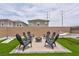 Relax in this backyard featuring an outdoor fire pit, hammock and artificial grass at 10292 Fragrant Apple Ct, Las Vegas, NV 89141