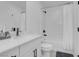 This bathroom has a white vanity, quartz countertop, and modern black fixtures and shower hardware at 10292 Fragrant Apple Ct, Las Vegas, NV 89141