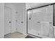 Well-lit bathroom features a frameless glass shower and white doors at 10292 Fragrant Apple Ct, Las Vegas, NV 89141
