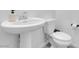 Simple powder room with modern toilet and pedestal sink offering efficient use of space at 10292 Fragrant Apple Ct, Las Vegas, NV 89141