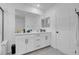 Bathroom with double sinks, quartz countertop, and matte black hardware at 10292 Fragrant Apple Ct, Las Vegas, NV 89141