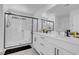 Bathroom features a modern walk-in shower with glass doors and double sink vanity at 10292 Fragrant Apple Ct, Las Vegas, NV 89141