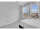 Bright bedroom featuring large windows with decorative curtains and a closet with sliding doors at 10292 Fragrant Apple Ct, Las Vegas, NV 89141