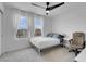 This bedroom has neutral paint, carpet, and decor with a ceiling fan and plenty of natural light at 10292 Fragrant Apple Ct, Las Vegas, NV 89141