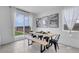Bright dining area with modern table set next to a backyard view and natural light at 10292 Fragrant Apple Ct, Las Vegas, NV 89141