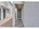 A welcoming entryway featuring a green front door adorned with a wreath and stone walkway at 10292 Fragrant Apple Ct, Las Vegas, NV 89141