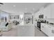 Bright, open-concept kitchen featuring white cabinets, stainless steel appliances, and large quartz island at 10292 Fragrant Apple Ct, Las Vegas, NV 89141
